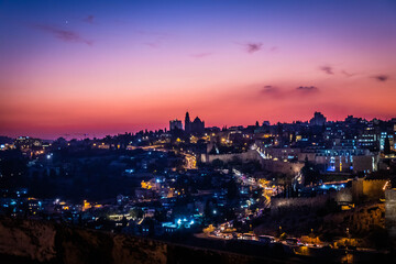 Fototapeta na wymiar panorama of jerusalem from Jewish cemetery on the Olive Hill with a mosque dome on the rock in the light of the setting sun