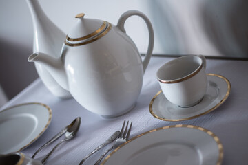 Set of porcelain tableware,  prepared on a table in a modern restaurant.