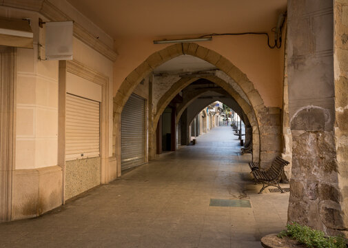 a street with arches in Tarrega city, Province of Lleida, Catalonia, Spain