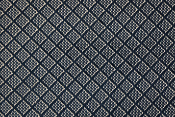 detail of a non-slip black surface with a pattern of squares