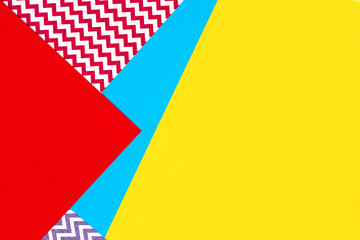 Abstract geometric fashion papers texture background in yellow, red, pink, blue colors. Top view, flat lay