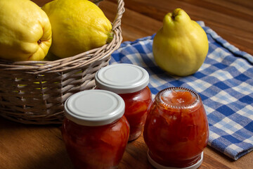 ripe quince and jars with quince jam