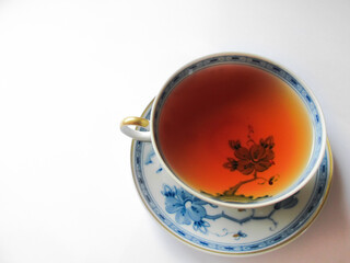 Lotus flower traditional tea cup with black tea on white background