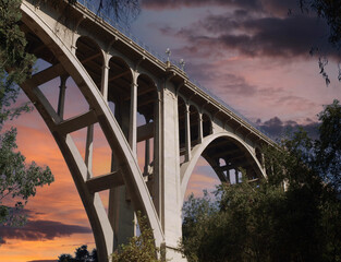 Historic Colorado Boulevard Bridge in Pasadena California with sunset sky.