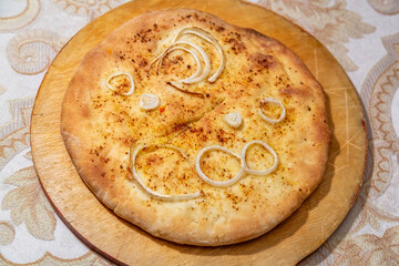 Freshly cooked delicious closed pie with hot cheese inside