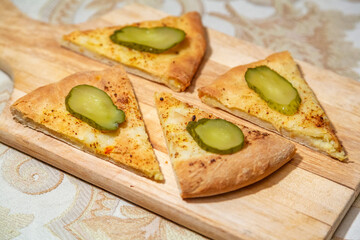 Freshly cooked delicious closed pie with hot cheese inside
