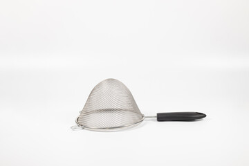 Closeup shot of a sieve on white background