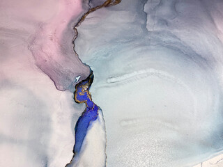 Pink, violet and blue abstract background made with alcohol ink and gold pigment