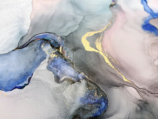 Pink, violet and blue abstract background made with alcohol ink and gold pigment