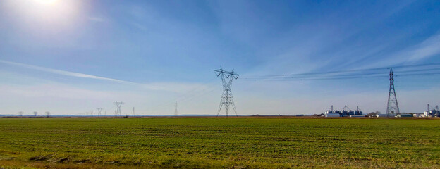 Farmland after plowing with electric pylon in Quebec, CanadaFarmland after plowing with electric...