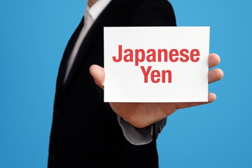 Japanese Yen. Businessman in suit showing business card with text. Man isolated on blue background