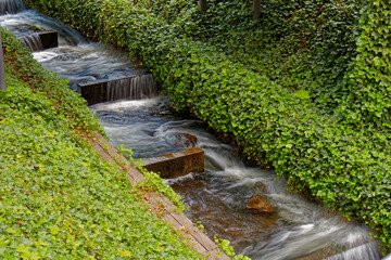 Close-up of flowing water in an artificial stream in a city park.