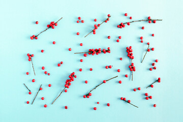 Christmas  modern composition. Pattern made of red berries on pastel blue background. Christmas, New Year, winter concept. Flat lay, top view, copy space © prime1001