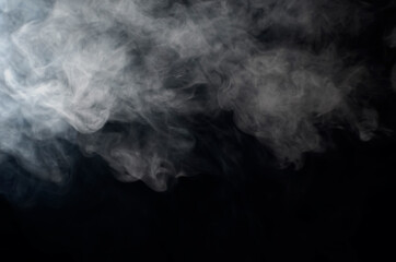 puffs of smoke thick on a black background close-up