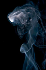 Smoke streaming on a black background close-up