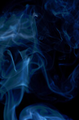 Smoke streaming on a black background close-up