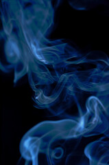 Smoke streaming on a black background close-up