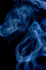 Smoke streaming on a black background close-up