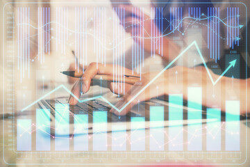 Multi exposure of woman hands typing on computer and financial graph hologram drawing. Stock market analysis concept.