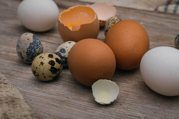 closeup of several eggs on beige white wood of chicken and quail egg some broken cordoba argentina