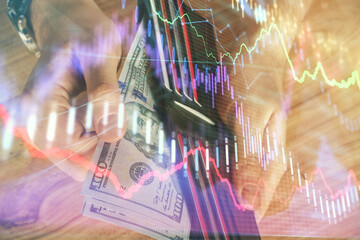 Multi exposure of forex graph drawing hologram and USA dollars bills and man hands. Technical Analysis concept.