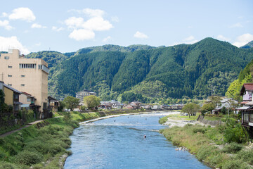 Fototapeta na wymiar An angler entering the Yoshida River in Gujo City, Gifu Prefecture