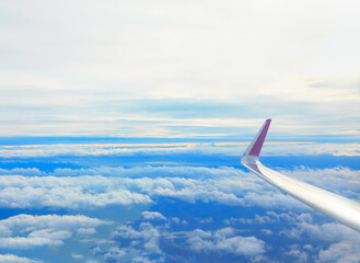 View from airplane window . Aircraft wing over the clouds 