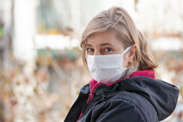 portrait of woman in medical mask outdoors