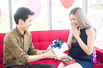 Romantic couple spent time for happy anniversary with holding hands together over romantic scene of relationship.