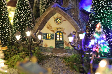 Fototapeta premium Miniature of Christmas scene old house in snow with winter concept, street, outdoor Christmas holidays