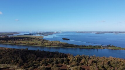 Fototapeta na wymiar Nature view with wind turbines farm. Over water seen from the air.