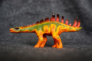 Closeup of a toy figurine of a stegosaurus dinosaur © Mirco Vacca/Wirestock