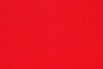 Background from red color texture of canvas non-woven fabric material in small rhombus. Close-up surface of blank bright abstract pattern backdrop, ready for text and copy space.