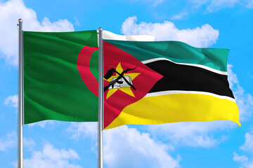 Mozambique and Algeria national flag waving in the windy deep blue sky. Diplomacy and international relations concept.