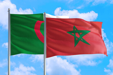 Morocco and Algeria national flag waving in the windy deep blue sky. Diplomacy and international relations concept.