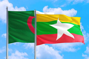 Myanmar and Algeria national flag waving in the windy deep blue sky. Diplomacy and international relations concept.