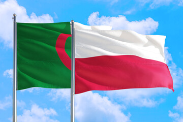 Poland and Algeria national flag waving in the windy deep blue sky. Diplomacy and international relations concept.