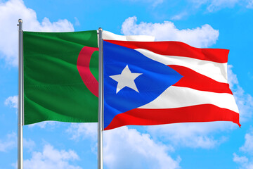 Puerto Rico and Algeria national flag waving in the windy deep blue sky. Diplomacy and international relations concept.