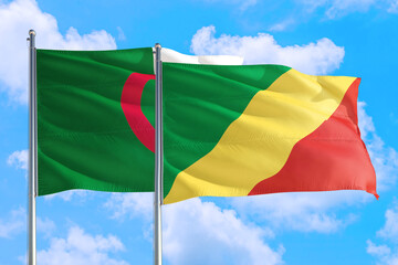 Republic Of The Congo and Algeria national flag waving in the windy deep blue sky. Diplomacy and international relations concept.