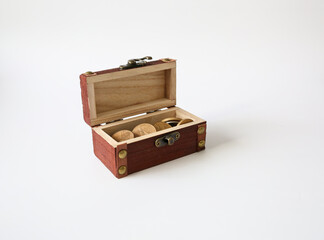 wooden treasure box and coins isolated on a white background