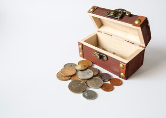 wooden treasure box and coins isolated on a white background