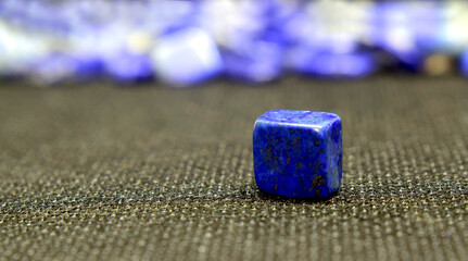 Lapis Is a beautiful natural gemstone on a wooden floor	