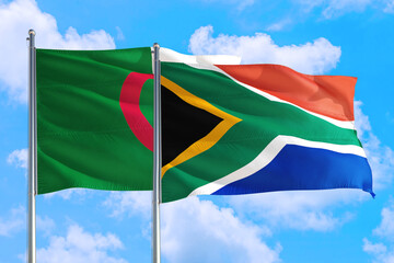 South Africa and Algeria national flag waving in the windy deep blue sky. Diplomacy and international relations concept.