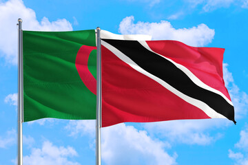 Trinidad And Tobago and Algeria national flag waving in the windy deep blue sky. Diplomacy and international relations concept.