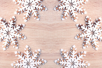 Christmas New Year background with white snowflakes on wooden surface with copy space.
