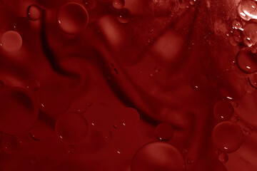 Red glitter vintage lights background. Red texture background. Oil drops in water.