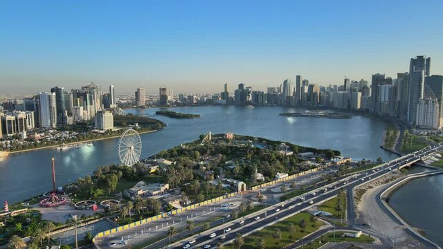 Aerial view of Khalid Lake and Sharjah city skyline on a beautiful afternoon, Travel tourism business in the United Arab Emirates. 4k Footage