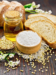 Flour buckwheat green in bowl with bread on dark wooden board
