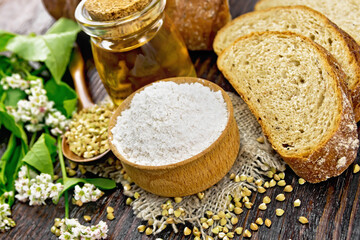Flour buckwheat green in bowl with bread on wooden board