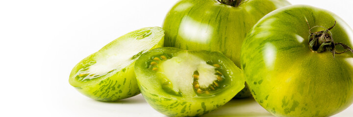 Close up of organic green tomatoes isolated on white background